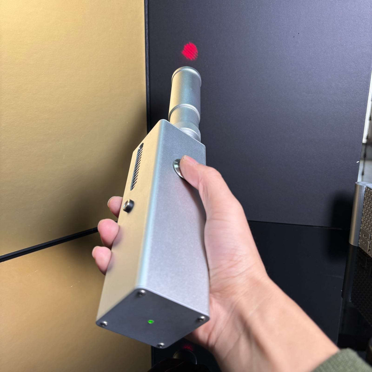 130W professional laser igniter showing coaxial red aiming guide in a controlled setting