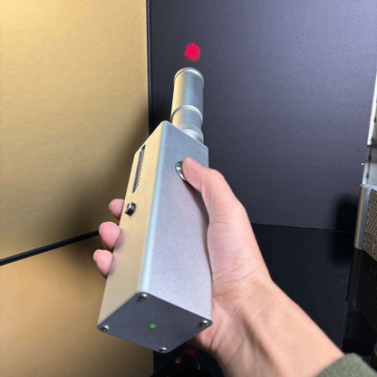 130W professional laser igniter showing coaxial red aiming guide in a controlled setting